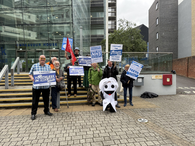 Toothless in England campaigners outside Endeavour House, the headquarters of Suffolk and North East Essex Integrated Care Board