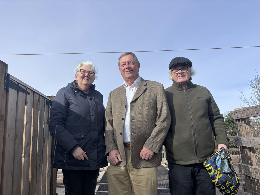 Cllr Malcolm Buckley with Pam and John Girling at the level crossing in Shotgate.