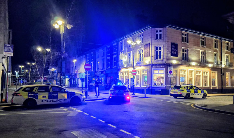 The 21-year-old man, who walked across the roof of multiple Crewe town centre businesses, was later brought to safety and arrested (Photo: Nub News).