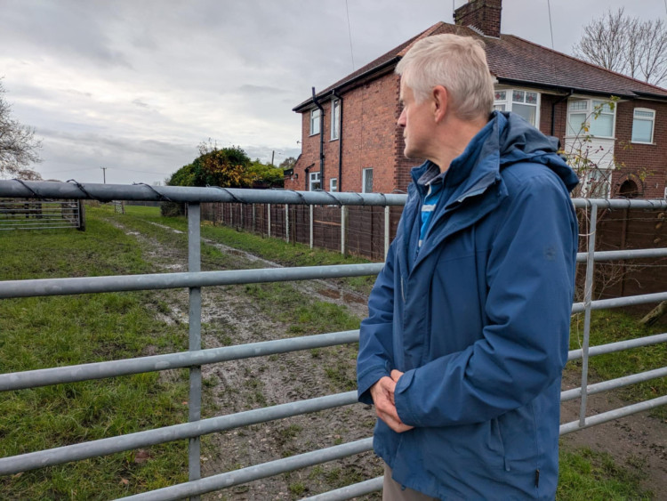 Crewe Road resident, Peter Osborne, at one of the entrances. (Photo: Nub News)