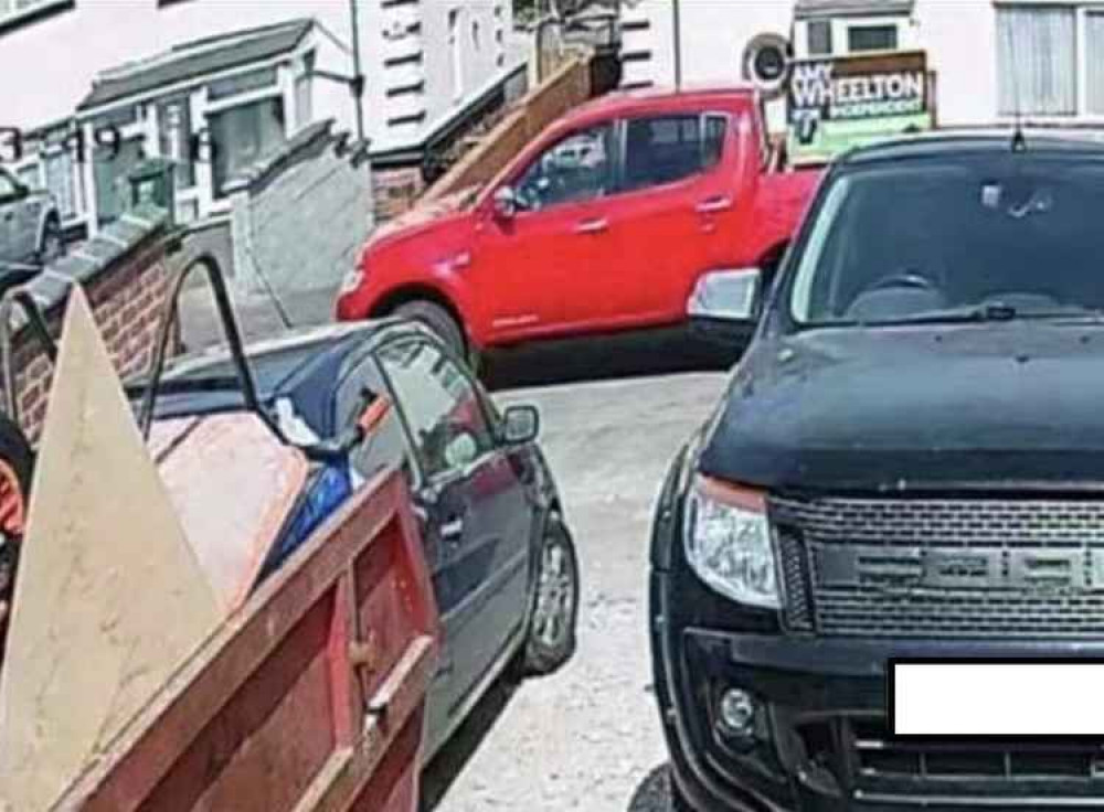 A screenshot from Amy Wheelton's public Facebook page showing her standing beside her red pickup truck, with an election poster board mounted in the back A screenshot from Amy Wheelton's public Facebook page showing her standing beside her red pickup truck, with an election poster board mounted in the back