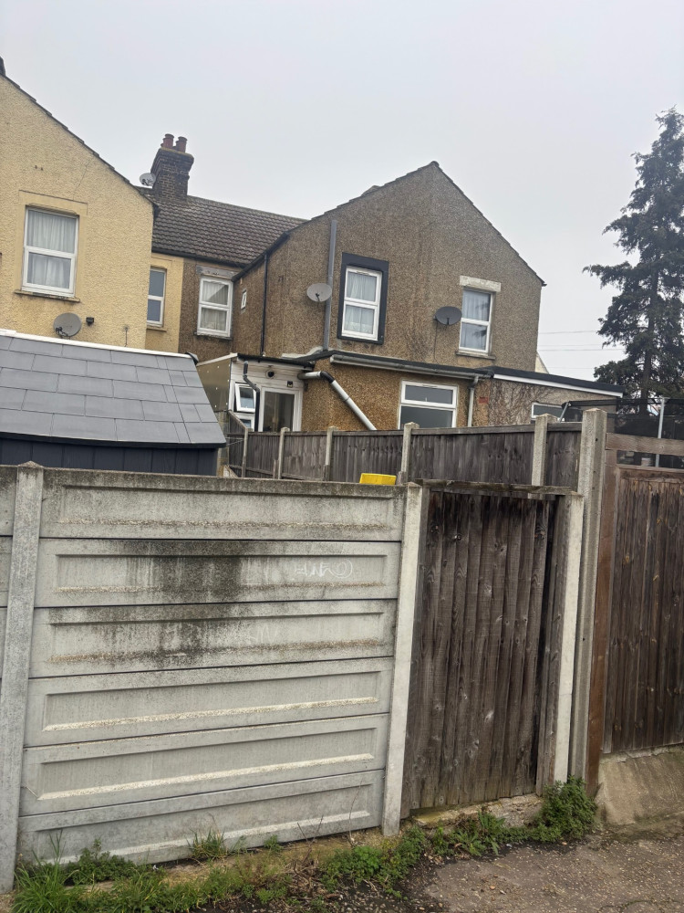 The extension is barely visible from the terrace's rear alley. 