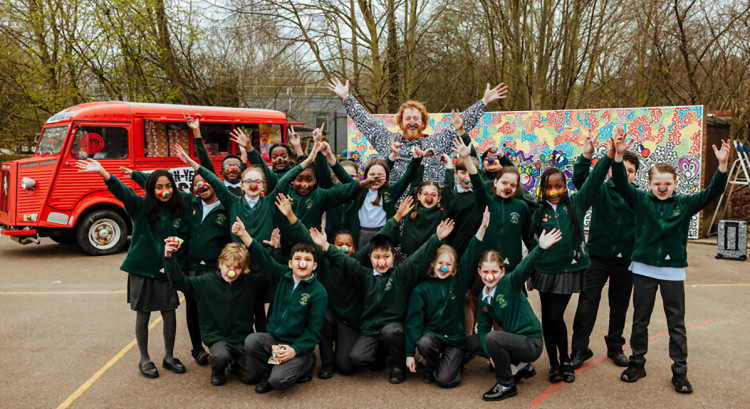 Pupils from Warren Primary with Mr Doodle in front of the mural they created.