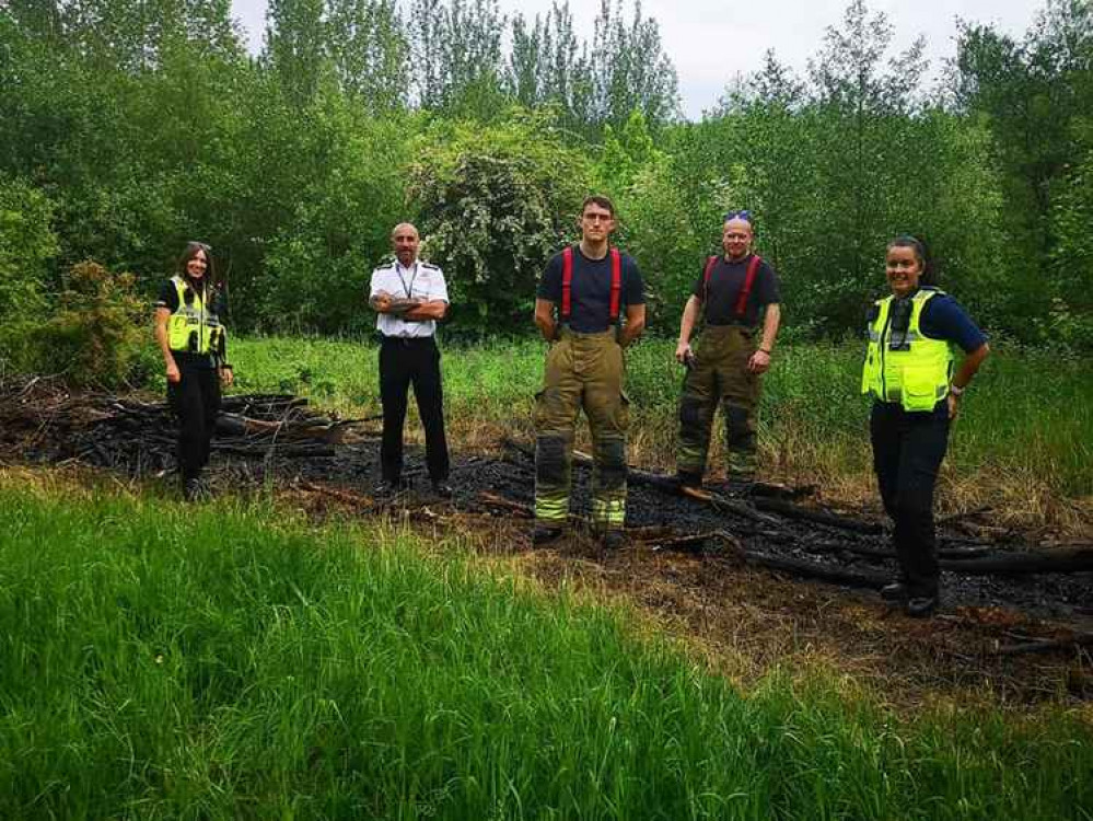 Swadlincote Police and Derbyshire Fire Service survey the damage caused by arsonists at The Woodlands. Photo: Swadlincote SNT