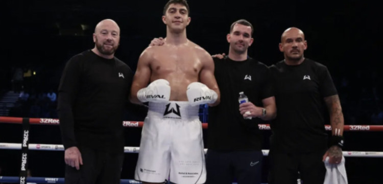 Lewis Williams in the ring (second left) (images via https://lewiswilliamsboxing.com/)