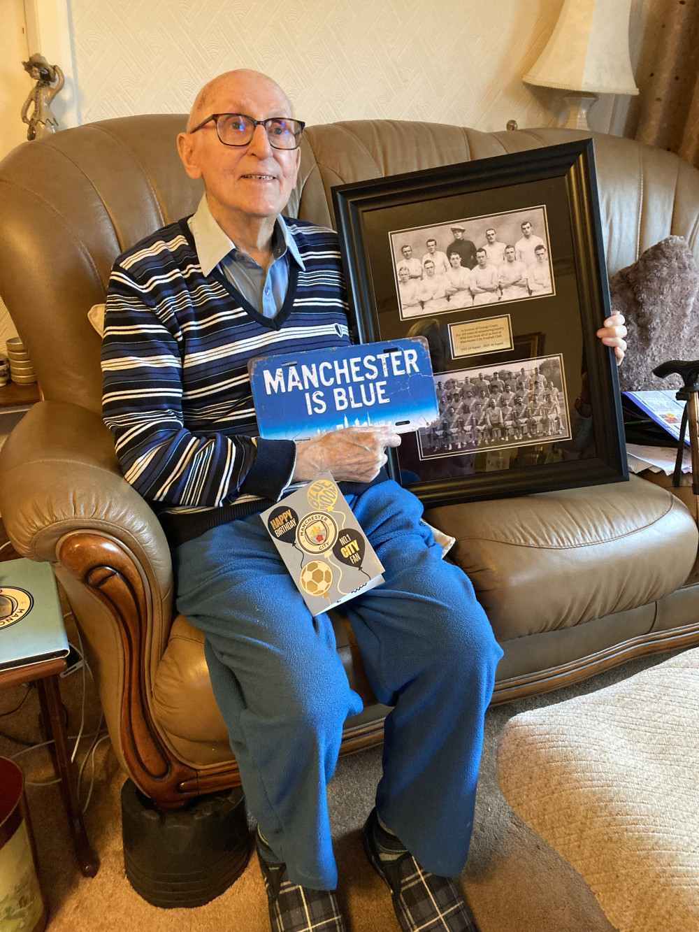 Retired sports journalist, George Court, received a card signed by all the Manchester City players and a picture commemorating him as their oldest fan. (Photo: Jo Rogers)