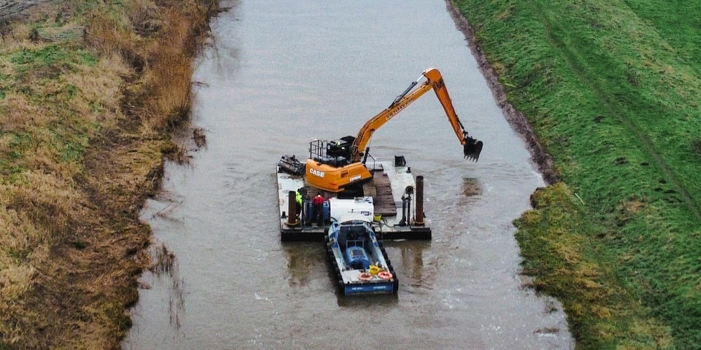 An excavator dredging the River Parrett near Moorland. CREDIT: Somerset Rivers Authority.