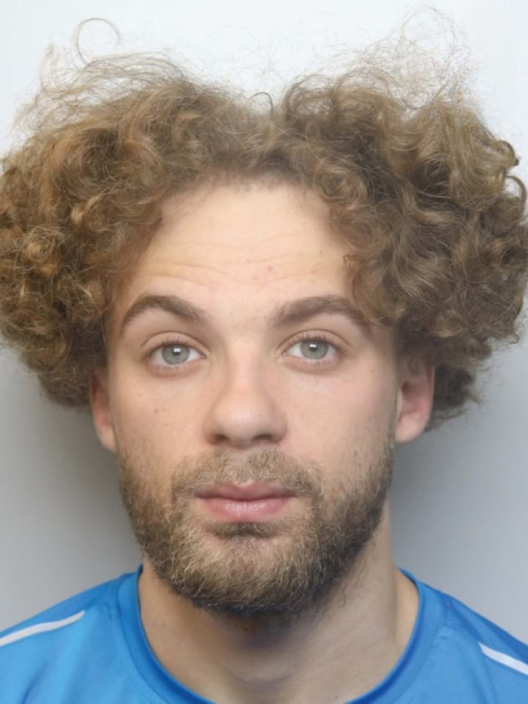 Kai Dodd, 26, is wanted in connection with breaching a restraining order (Photo: Cheshire Police).