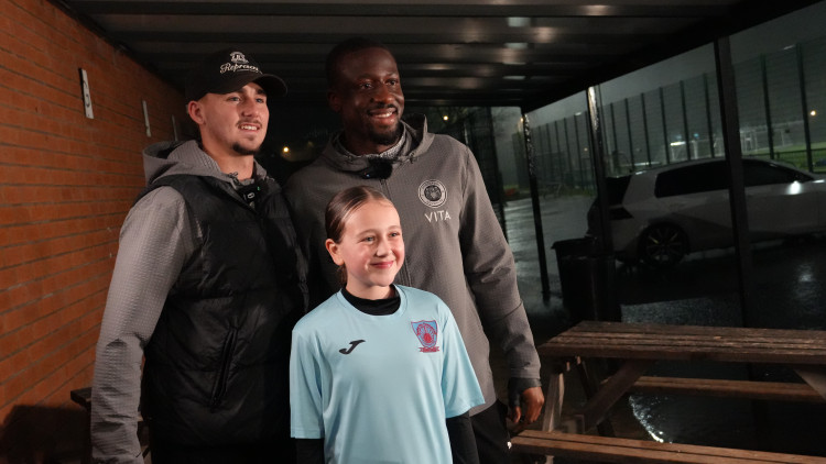Stockport County stars Jack Diamond and forward Joseph Olowu presented the Spurley Hey players with their tickets in a surprise visit (Image - Vertu)