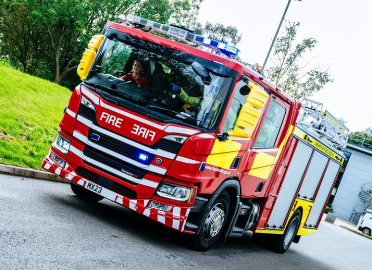 Firefighters rescue dog owner who became trapped waist-deep in mud after going into a pond to retrieve their dog.  (Photo: Nub News)