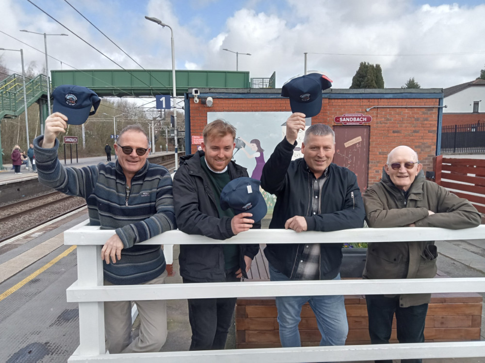Tim and Ryan are pictured at Sandbach station with Hugh Everett, secretary of the Rail Ale Trail organising committee (left), and Mark Barker, Chairman of Cheshire Best Kept Stations (right). (Photo: Friends of Sandbach station/FOSS)S