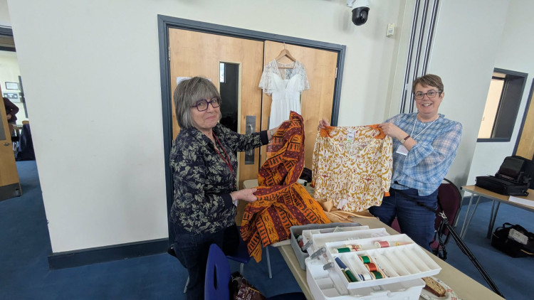 Helen Dorney (right) with another volunteer with some of the costumes they worked on for the gang show. (Photo: Nub News)