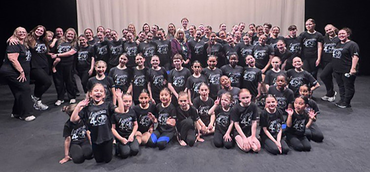 The cast and supporting team on stage.
