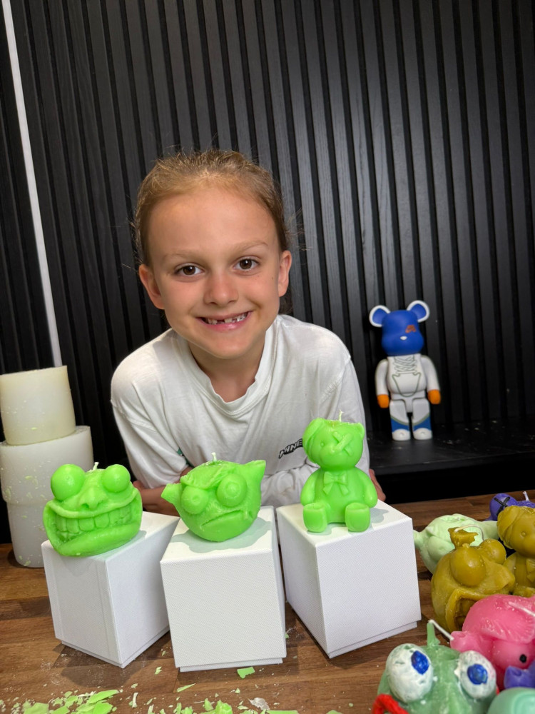 Barron, age 7 who lives in Tolworth, with one of his hand-sculpted  Moonsters, collectible monster candles he designs entirely himself from clay (Image supplied)