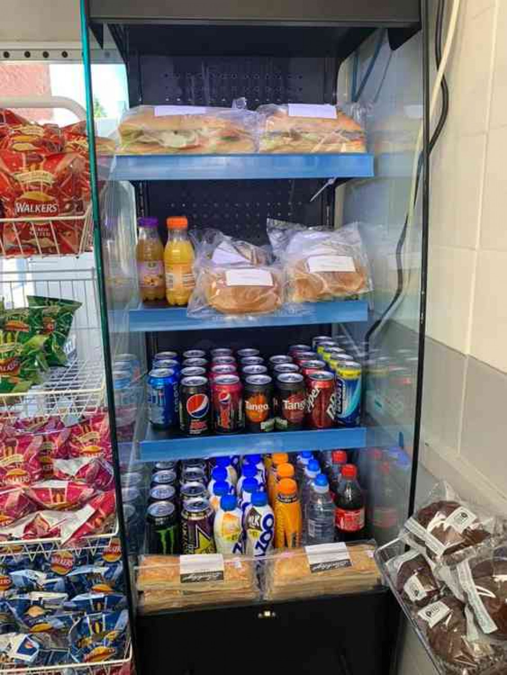 The new fridge loaded up with sandwiches and drinks