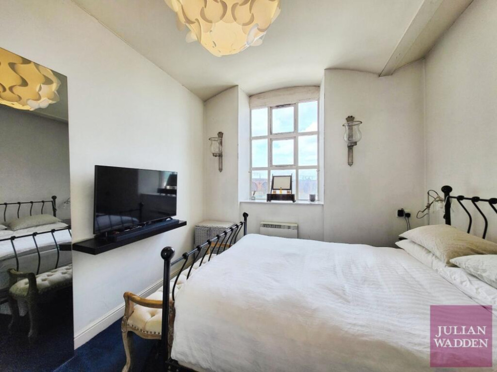 Our friends and sponsors at Julian Wadden present their property of the week - this spacious apartment in the historic Wellington Mill in Stockport town centre (Image - Julian Wadden)