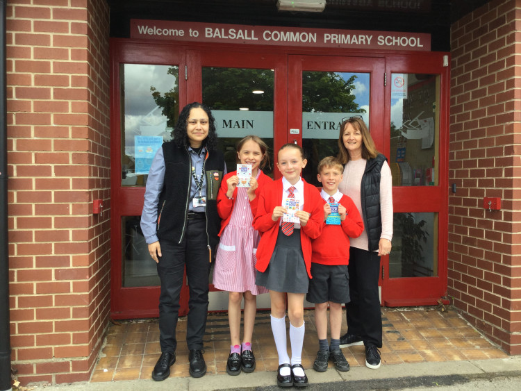 Manpreet Bains, Deputy Headteacher, runner up and winner (middle) pupils holding awarded book vouchers and Lisa Webb, Persimmon Homes Divisional Head of External Affairs (Central)