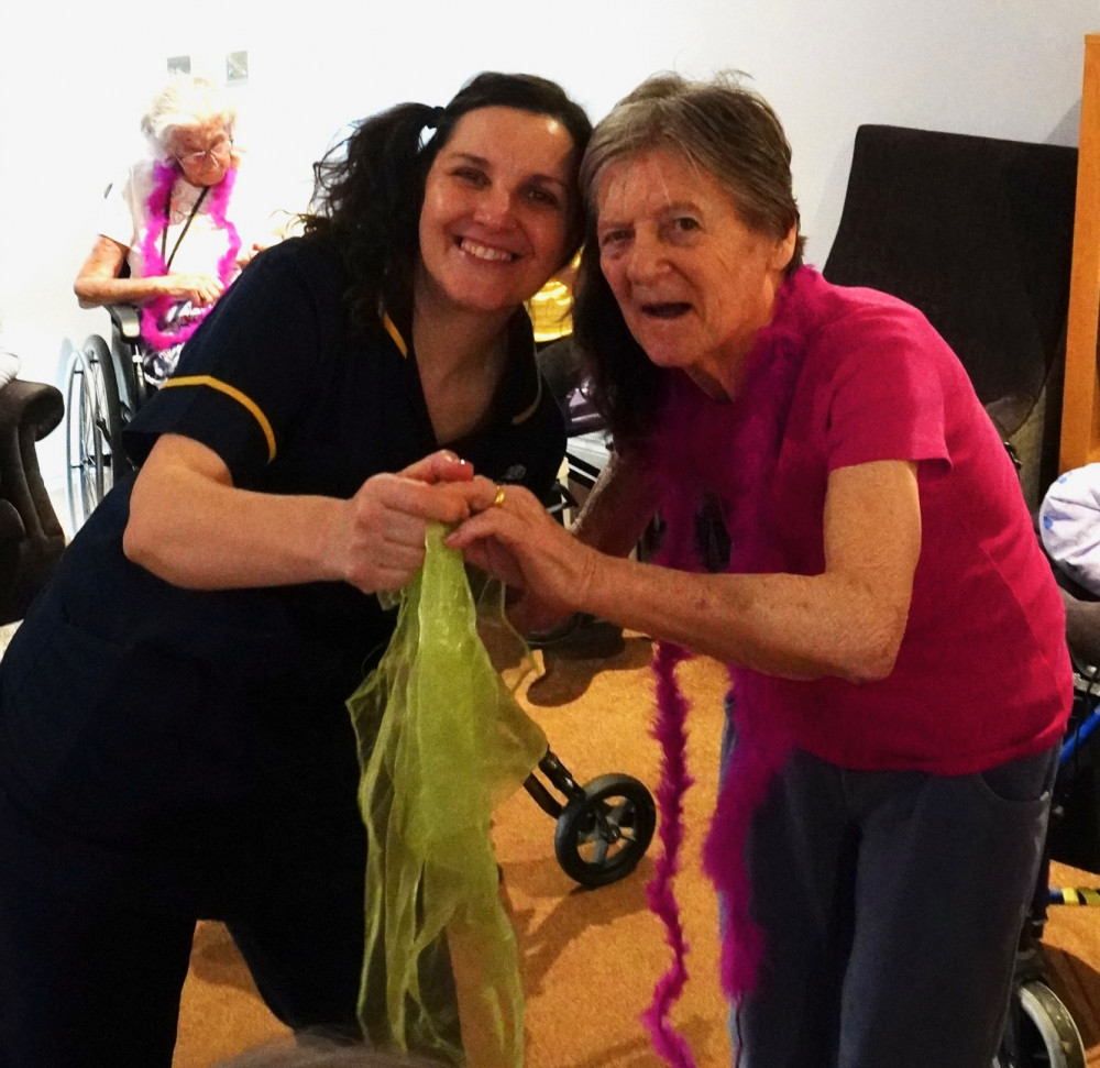 Crandon Springs Dementia Nurse Specialist, Isabel, enjoying the disco with resident Gillian who said, "I haven't had such a great time dancing like this in years."