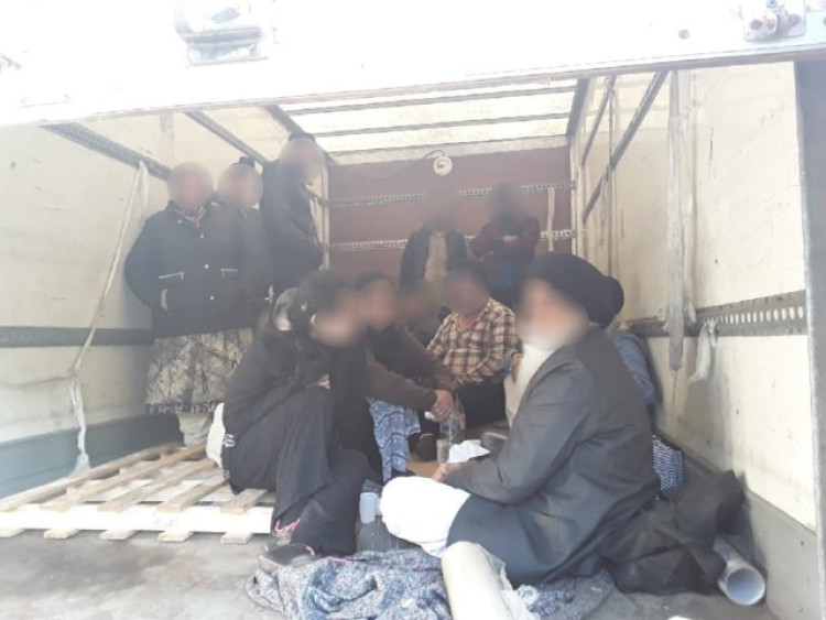 Migrants pictured inside the truck when it was stopped.