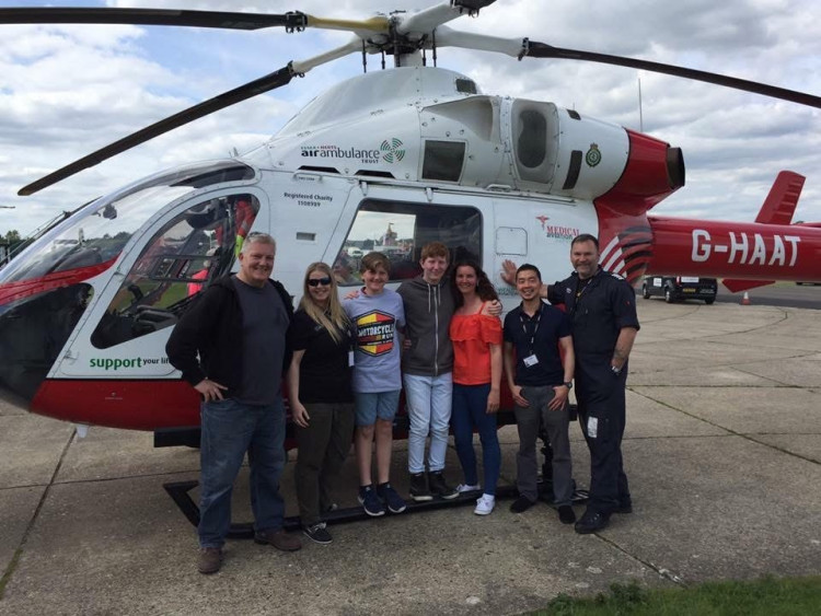 Karen Drew with Jacob and family members on a visit to see the air ambulance. 