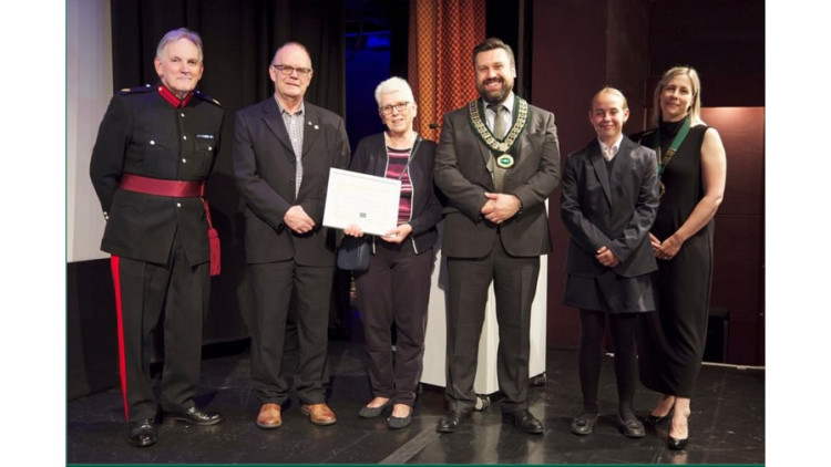  Lieutenant Colonel Michael Motum DL, Freedom of Street recipients David and Catherine Atkins, Street Parish Council chair Cllr Bryan Knickerbocker, Youth Cadet Eva Dowden, and vice chair Cllr Anna Thomson. (Photo credit: Will Punter.) 