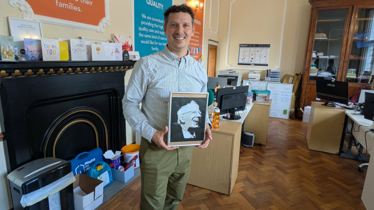 Right at Home South Cheshire owner Ben Selby holding a photo of his grandfather (Photo: Nub News)