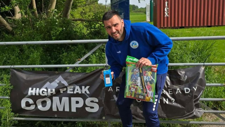 David Spruce, of Bollington United FC, pictured in front of a High Peak Comps banner (Image - Bollington United FC) 