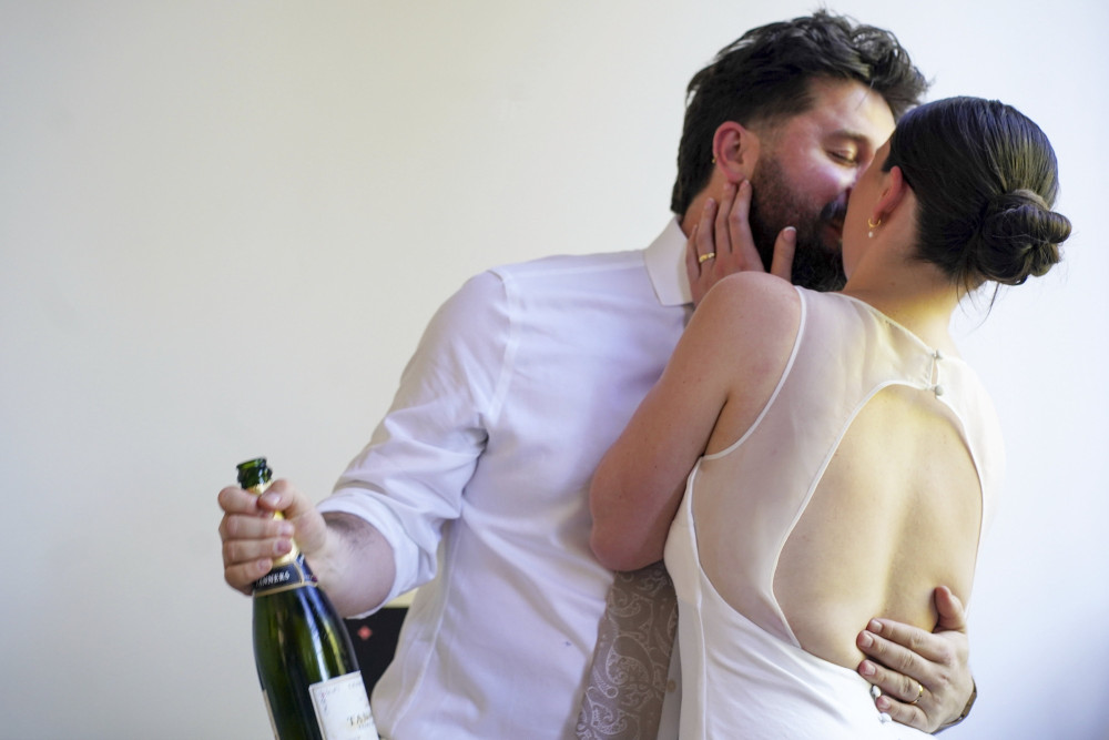 A savvy bride from Macclesfield bought her dream wedding dress for £5 from a charity shop and confetti from Vinted - for a ceremony costing less than £5,000 (Credit: SWNS)