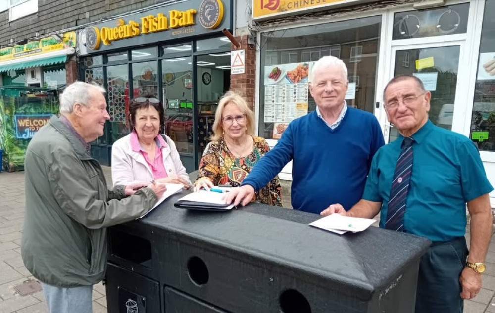 A resdient signs up watched by Plaid councillors Anne Asbrey, Marianne Cowpe, Chris Franks and Malcolm Phillips.