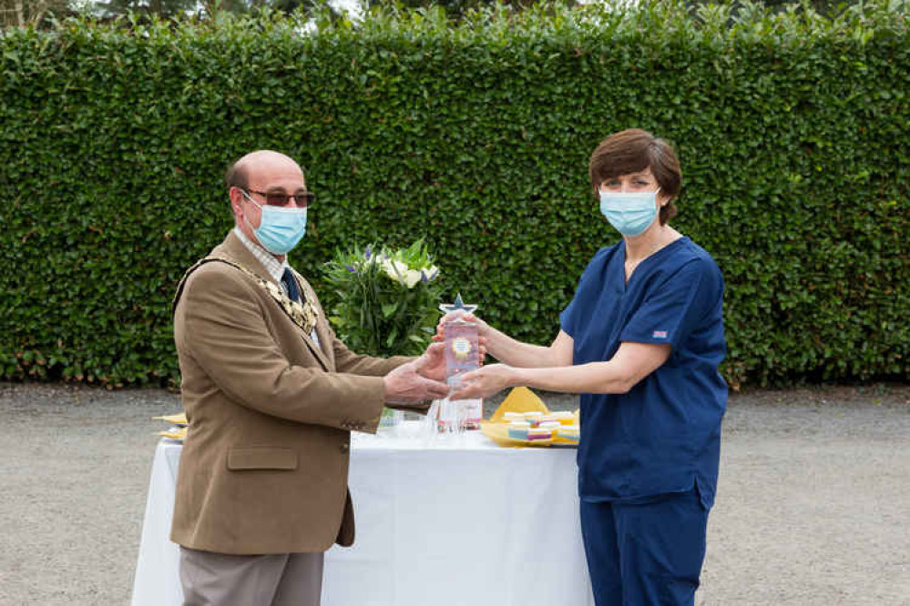 Diane Storer, owner at Cockburn, receives the award from North West Leicestershire District Council chairman Virge Richichi