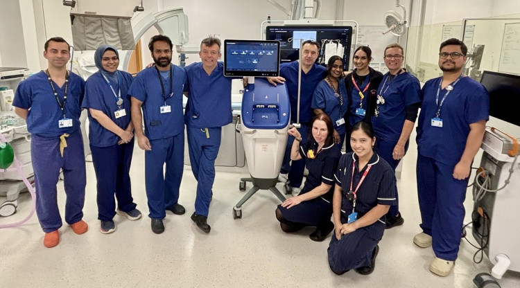 Professor Thomas Keeble, centre to the right of the console, with the research team.