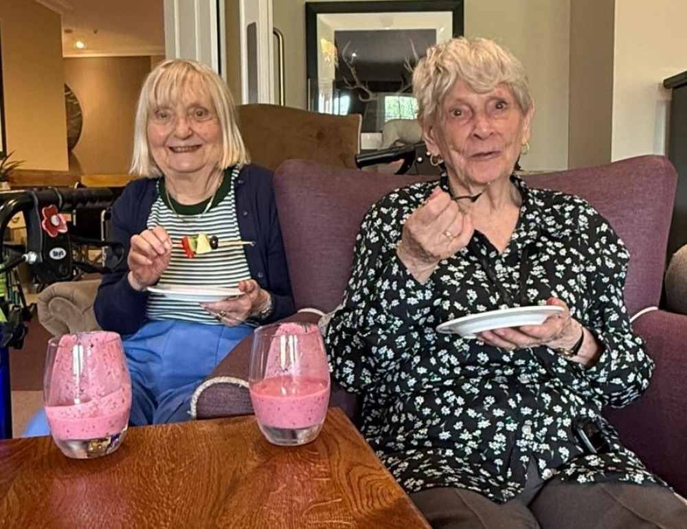 b)	Residents Christine and Sheila enjoying fresh smoothies and fruit kebabs during the Healthy Hydration sessions at Crandon Springs Care Home.