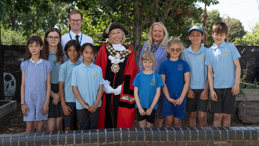 Pupils from East Sheen Primary School’s eco group joined Richmond Mayor Cllr Nancy Baldwin (centre), Cllr Cambridge and school staff to celebrate the new programme (credit: Richmond Council).