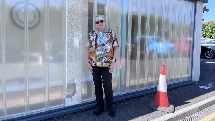  Housekeeping supervisor Jean Chaddock next to the broken window (Credit: East Cheshire Hospice)