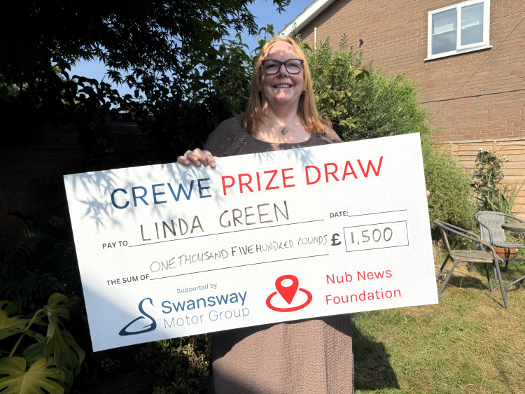 Linda Green, of Shavington, with her £1,500 winning cheque from the Crewe Prize draw