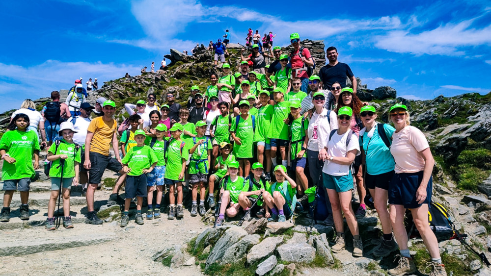 Parents and students from Marshgate Primary School at the summit of Snowdon in Wales (credit: Momentum Children's Charity).
