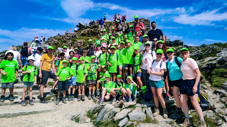 Parents and students from Marshgate Primary School at the summit of Snowdon in Wales (credit: Momentum Children's Charity).