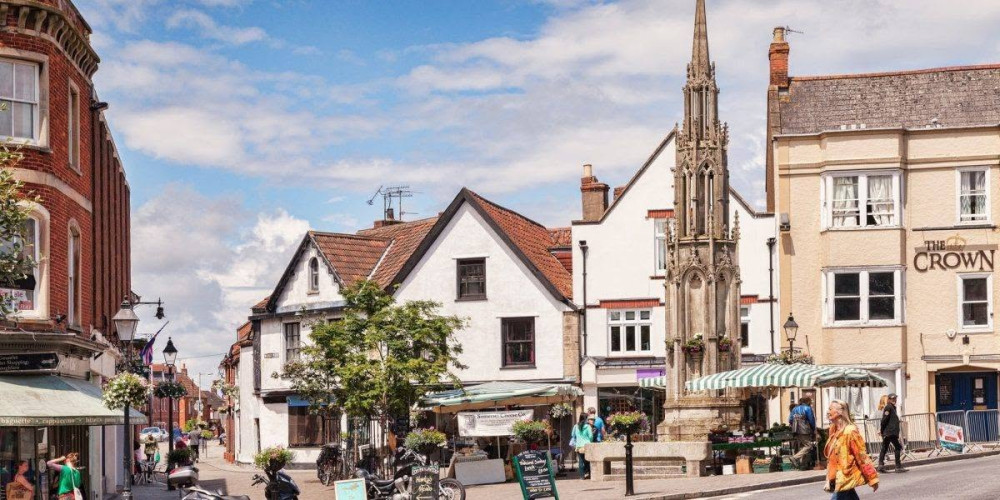 Glastonbury Town Council says scaffolding will remain around the historic Market Cross while repair plans are agreed for the Grade II listed structure. (Photo: GTC)
