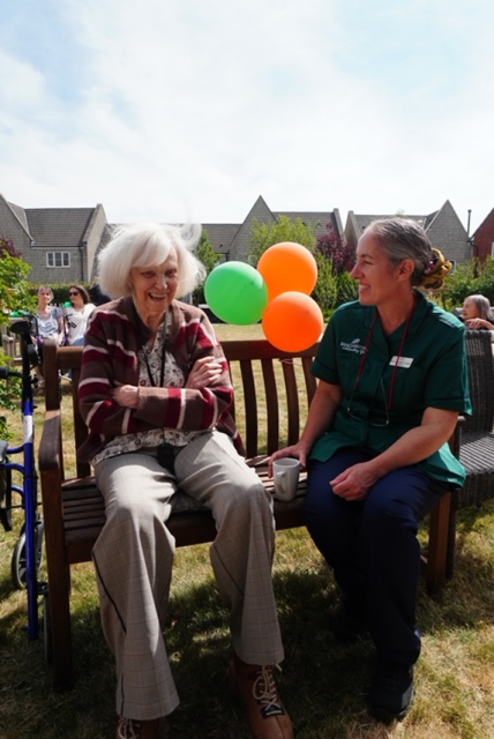 Resident Viv enjoying the sunshine and fun with Senior Carer Polly at Crandon Springs Care Home's Summer Party