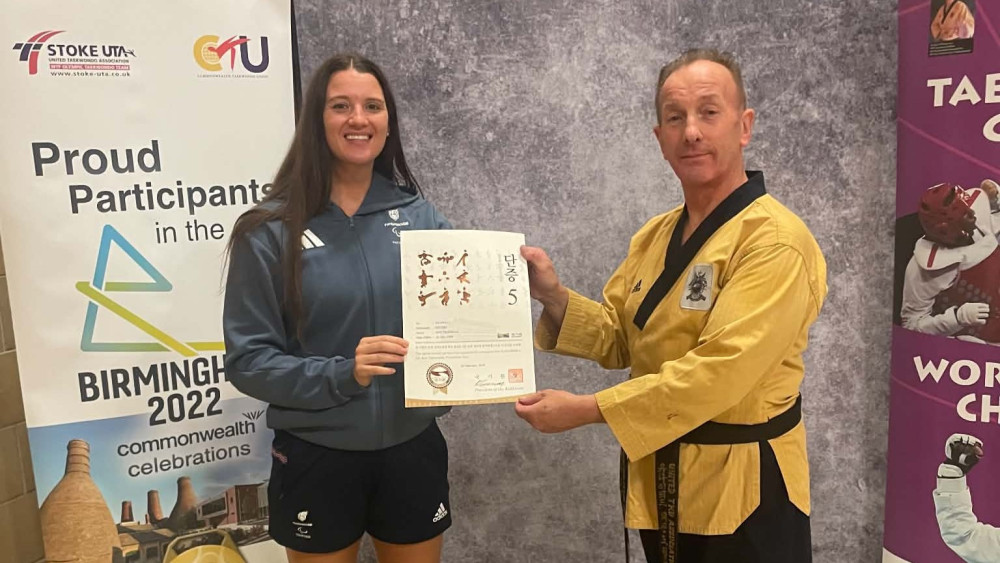 Amy Truesdale MBE is awarded her 5th Dan certificate by former coach Peter Johnson (image via Peter Johnson)