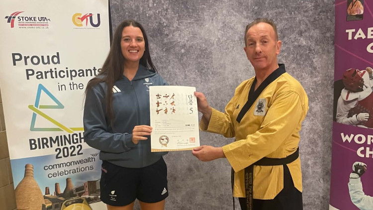 Amy Truesdale MBE is awarded her 5th Dan certificate by former coach Peter Johnson (image via Peter Johnson)