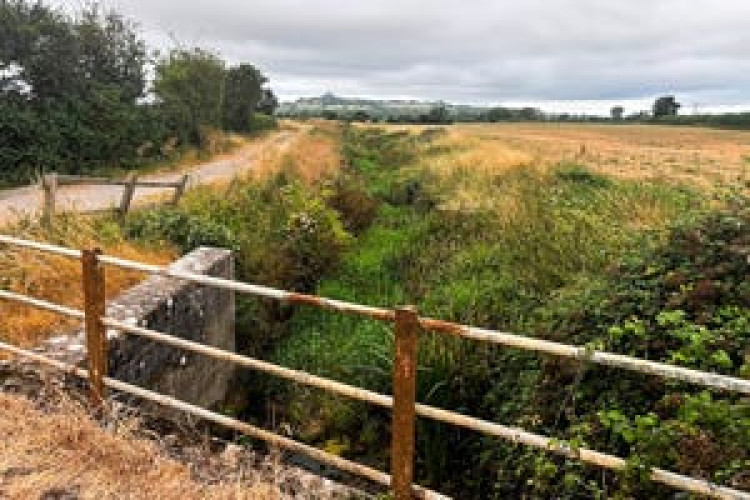 Whitelake River with Glastonbury Tor in the distance. CREDIT: Somerset Rivers Authority.