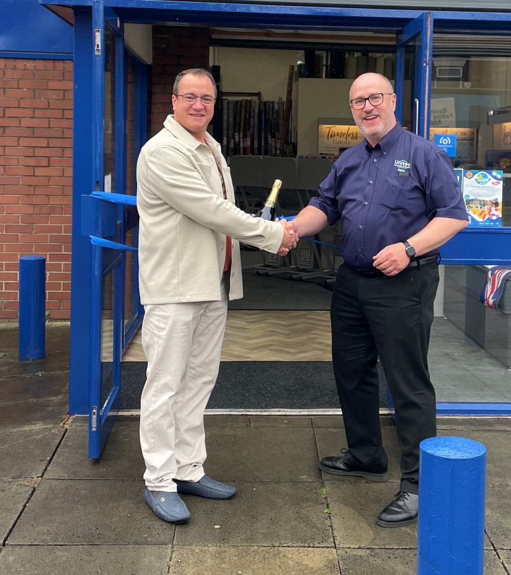 United Carpets owner Eddie Davies and Crewe BID Chair Graham Saunders celebrate the Nantwich Road store’s fresh new look (credit: United Carpets)