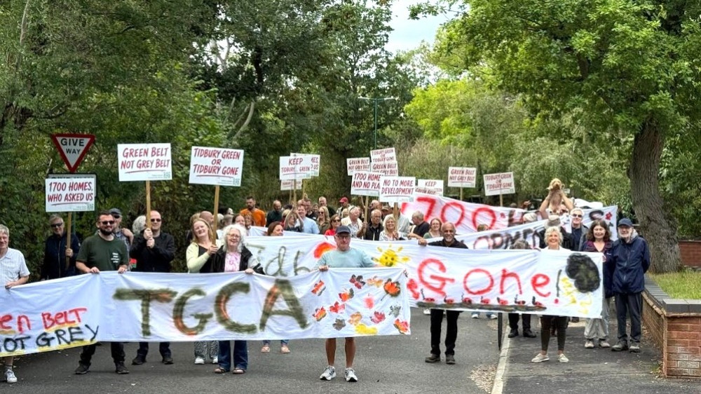 Villagers carried hand painted banners with messages such as “Green Belt Not Grey” (Picture: Tidbury Green Community Action)
