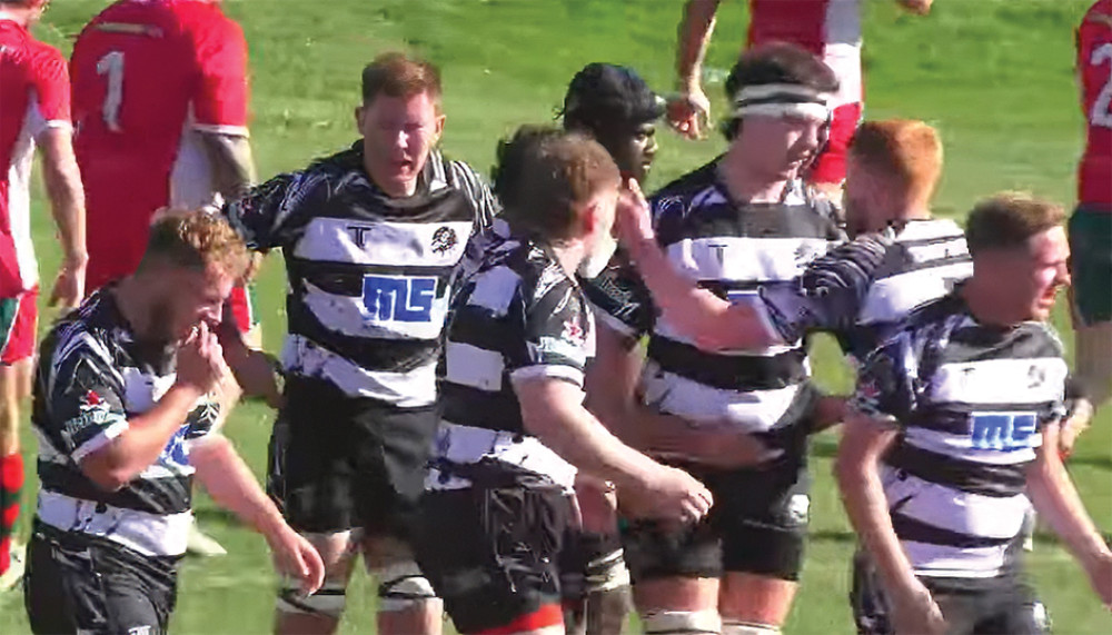 Kodie Holloway is congratulated by teammates after the first of his hat-trick of tries.