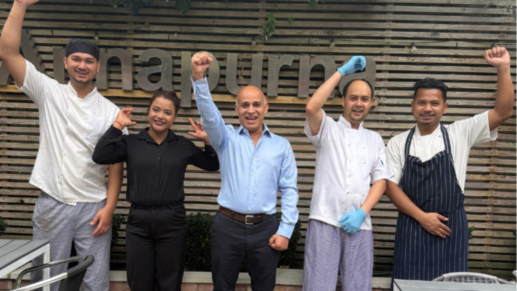 The Annapurna Restaurant team celebrating hitting their fundraising goal (credit: Image supplied).