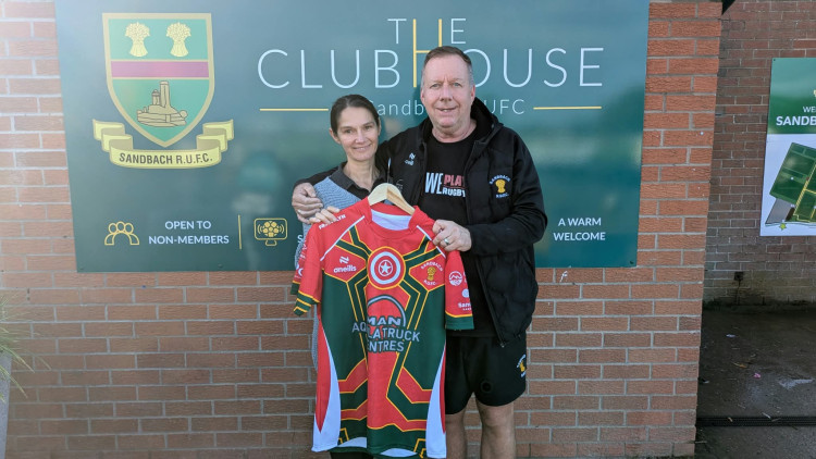 Aggie and Andy Milner with one of the shirts to be auctioned off to raise money for CRY. (Photo: Nub News)