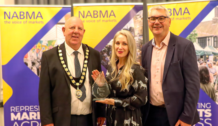 Councillor David Hopkins, President of NABMA; award winner Adele Thomas of Chester Market; and Mark Parry from ZAPP, the award sponsors (Image: supplied)
