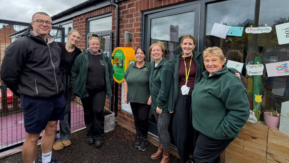 Callen Deighan of High Peak Comps to the left with staff of KinderView Day Nursery (Image - High Peak Comps)