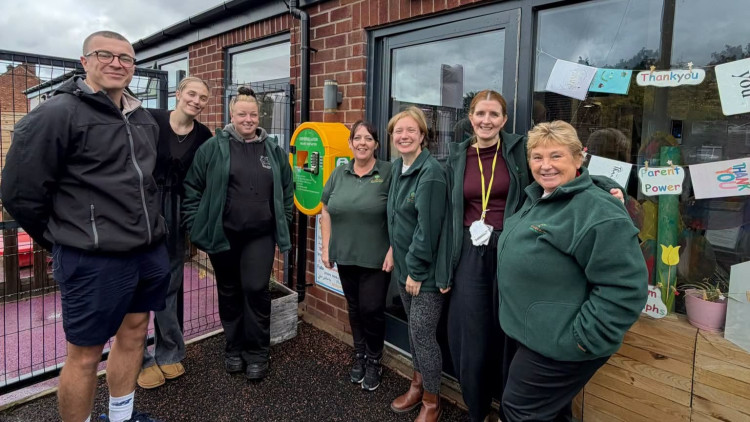 Callen Deighan of High Peak Comps to the left with staff of KinderView Day Nursery (Image - High Peak Comps)